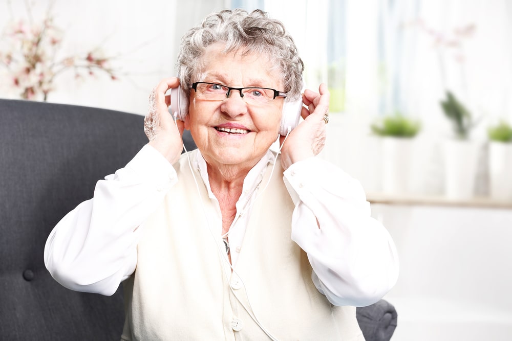 Senior woman smiling listening to music
