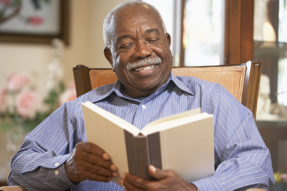 Smiling senior man reading a book