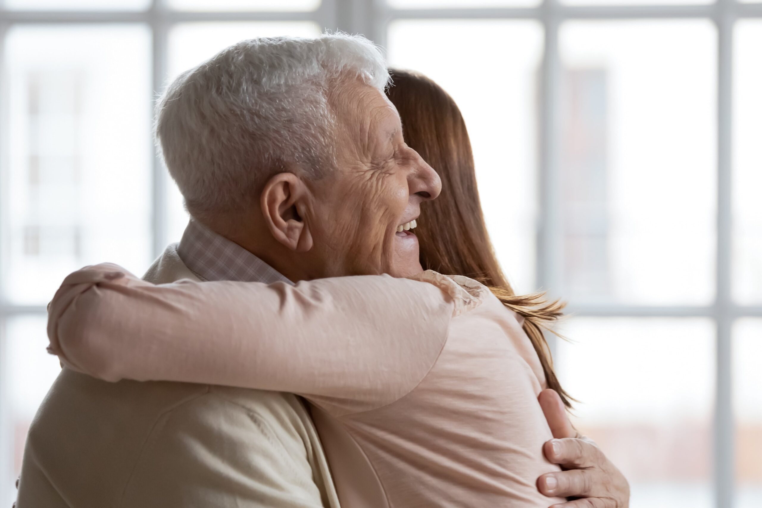 Senior man hugging granddaughter