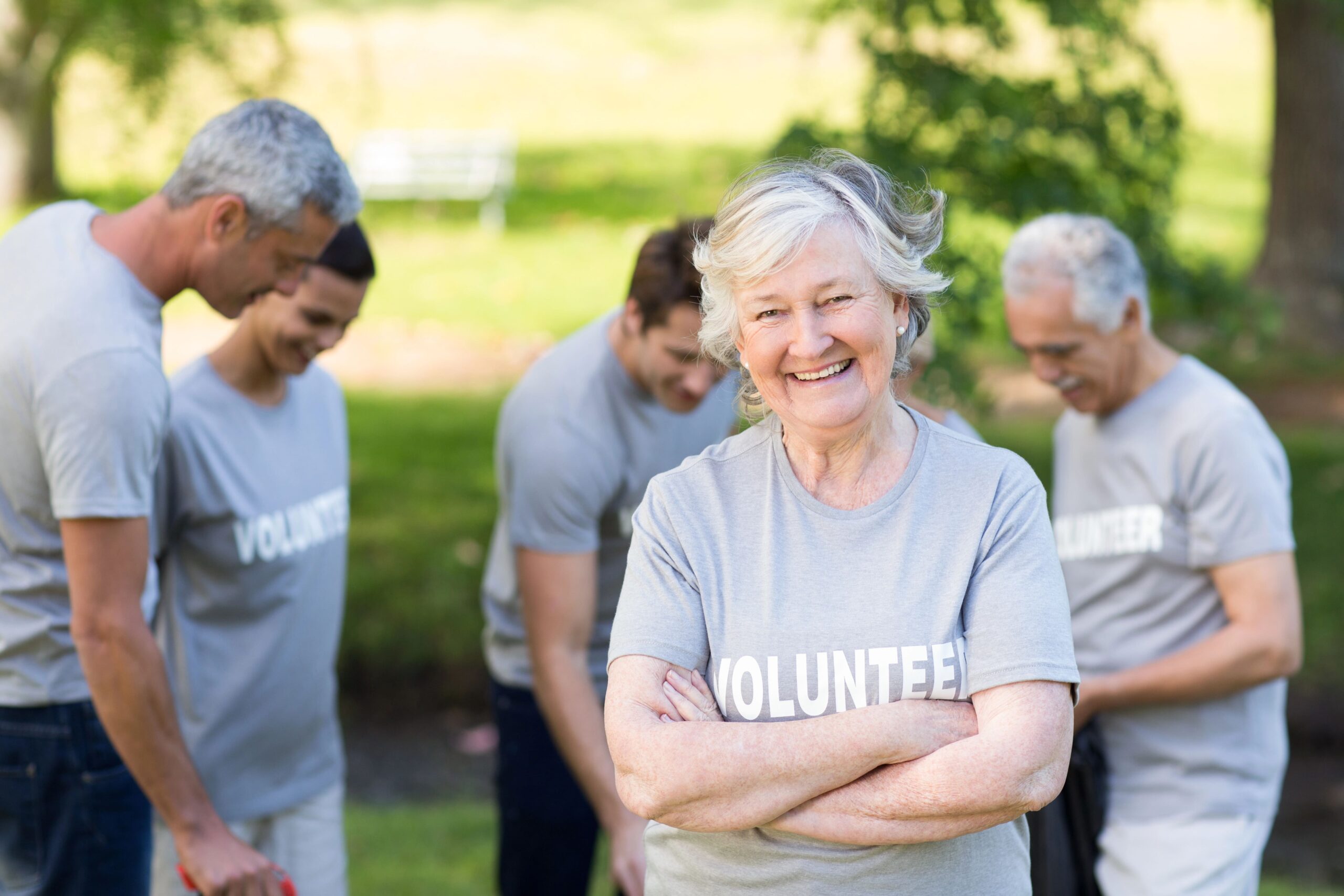 Senior woman volunteering with charity in park